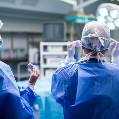 Rear view of surgeons preparing for operation in operation room